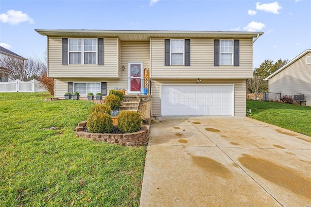 raised ranch featuring a front yard and a garage