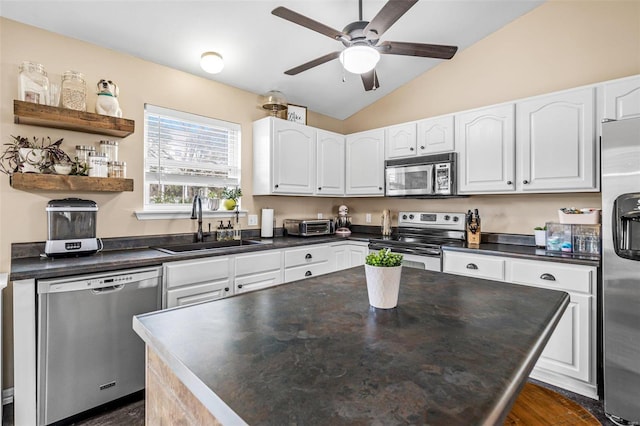 kitchen with white cabinetry, sink, lofted ceiling, and stainless steel appliances