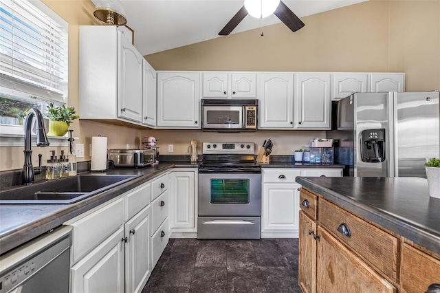 kitchen featuring white cabinetry, sink, ceiling fan, lofted ceiling, and appliances with stainless steel finishes