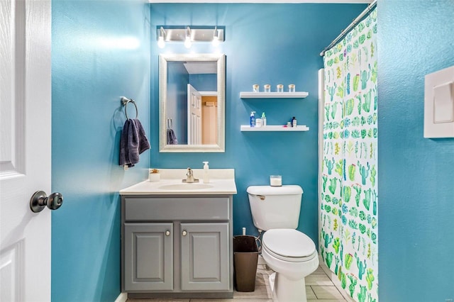 bathroom with tile patterned flooring, vanity, and toilet