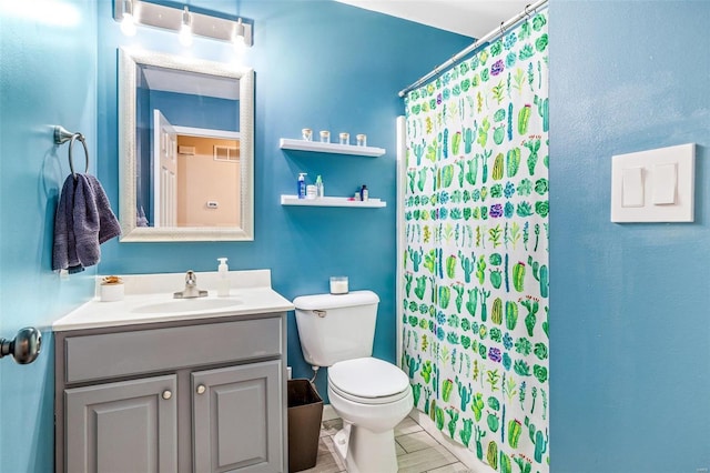 bathroom featuring vanity, a shower with shower curtain, and toilet