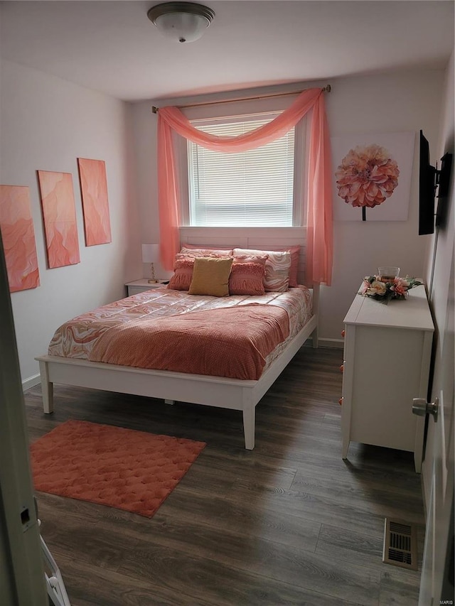 bedroom with dark hardwood / wood-style flooring