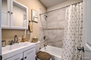 full bathroom with shower / bathtub combination with curtain, vanity, and toilet