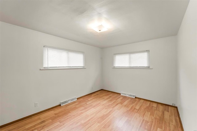 spare room featuring light hardwood / wood-style floors