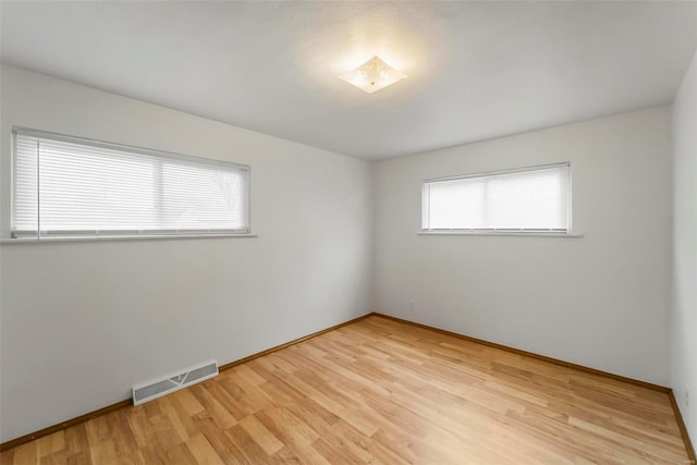 spare room featuring light wood-type flooring