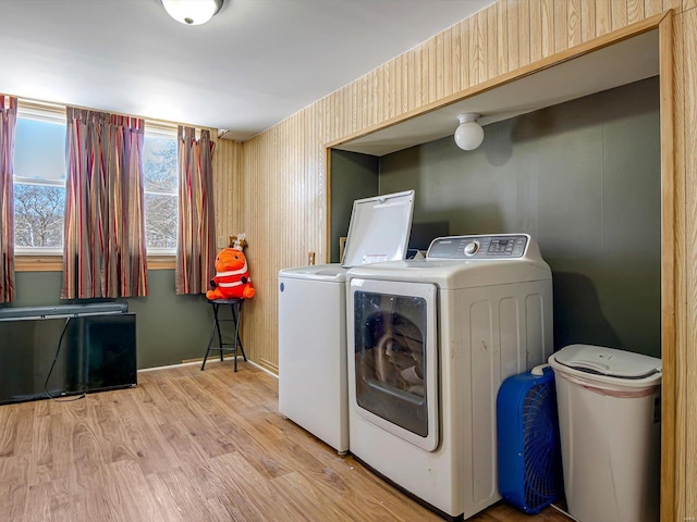 laundry room with laundry area, washer and clothes dryer, light wood-type flooring, and wallpapered walls