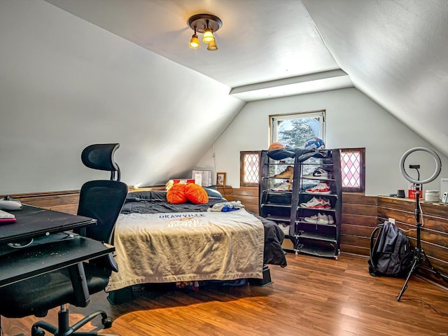 bedroom featuring vaulted ceiling and wood finished floors