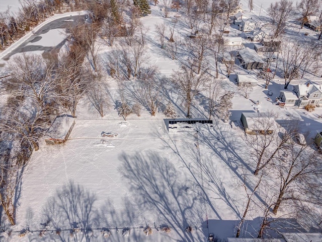 snowy aerial view with a residential view