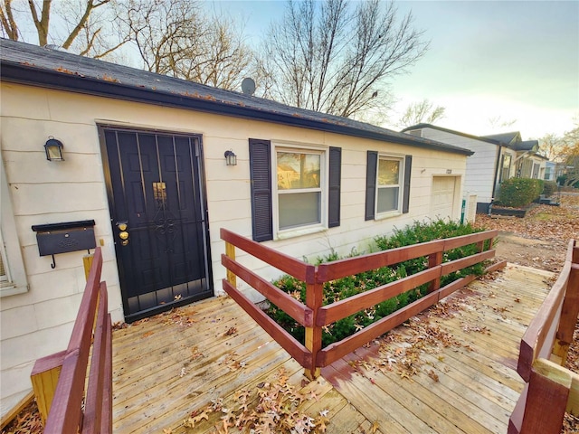 property entrance with a garage and a deck