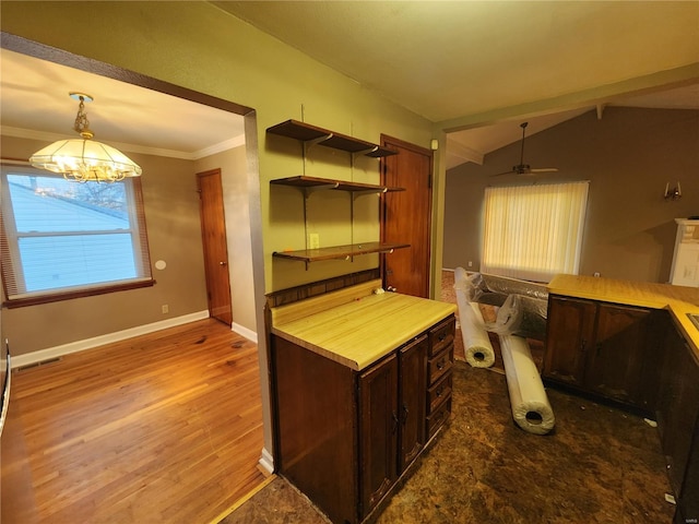 kitchen with hardwood / wood-style flooring, crown molding, hanging light fixtures, dark brown cabinetry, and vaulted ceiling