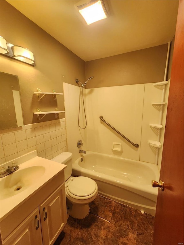 bathroom featuring washtub / shower combination, toilet, vanity, and tile walls