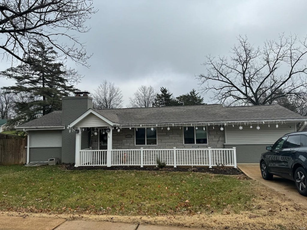 single story home featuring a garage and a front lawn