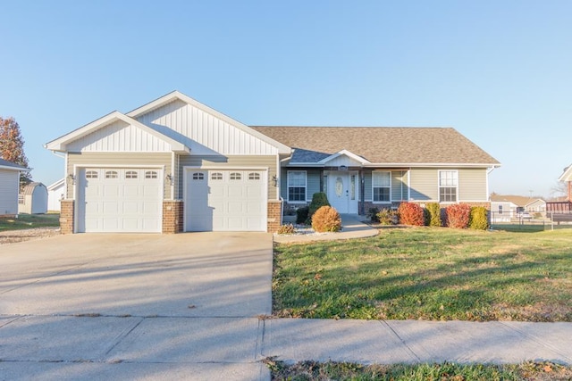 view of front of property with a garage and a front lawn