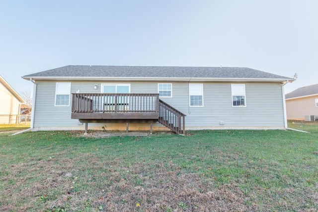 back of house with a deck, central AC unit, and a lawn