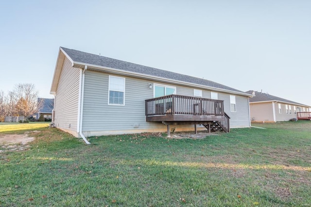 back of property featuring a yard and a deck