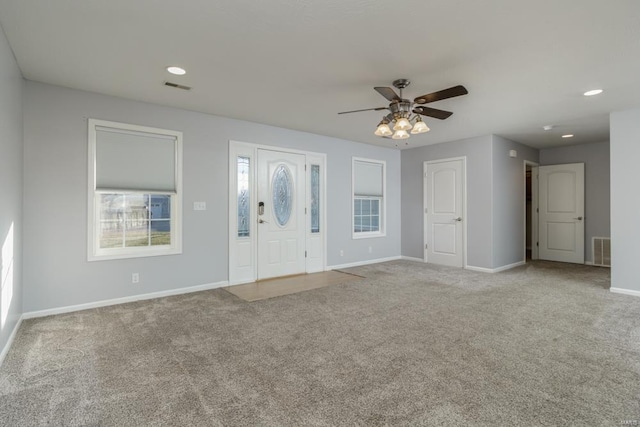 entrance foyer with light colored carpet and ceiling fan