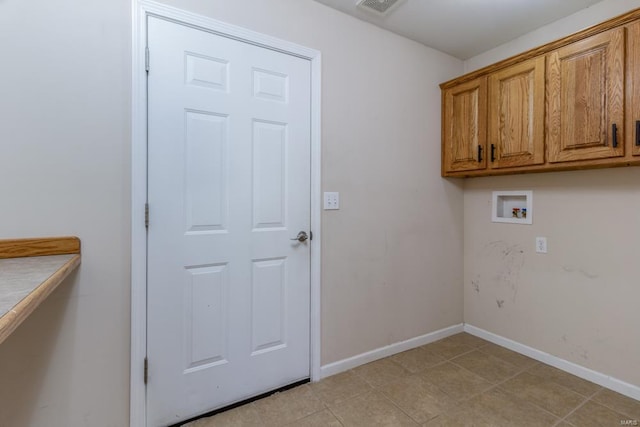 clothes washing area featuring cabinets and hookup for a washing machine