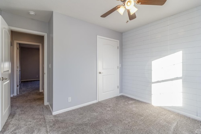 unfurnished bedroom with ceiling fan and light colored carpet