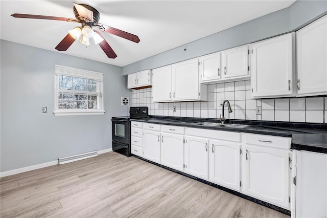 kitchen with backsplash, white cabinets, sink, light hardwood / wood-style flooring, and electric range