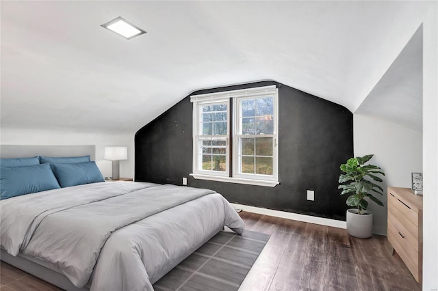 bedroom with dark hardwood / wood-style floors and vaulted ceiling