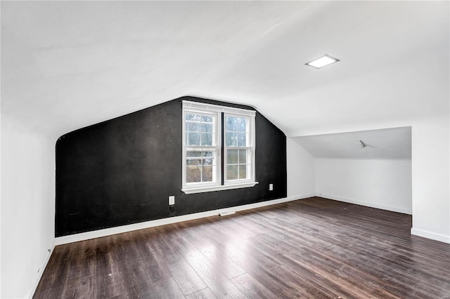 additional living space with lofted ceiling and dark wood-type flooring