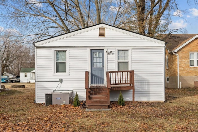 back of property featuring central AC