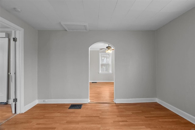 spare room with ceiling fan and light wood-type flooring