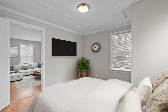 bedroom with hardwood / wood-style floors and ornamental molding