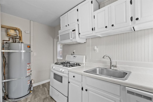 kitchen featuring white cabinetry, sink, water heater, and white appliances