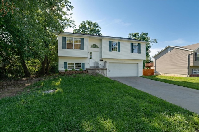 split foyer home with a front yard and a garage