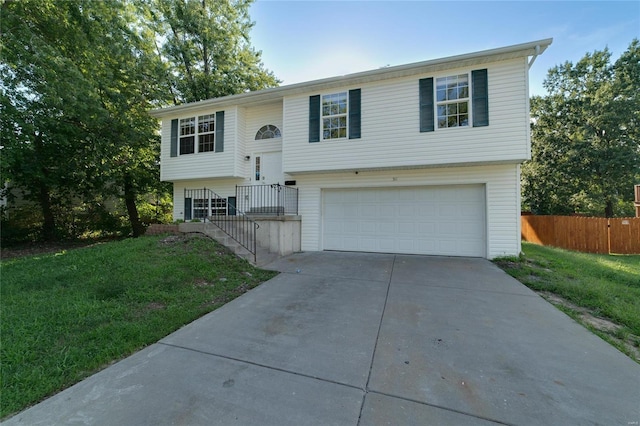 bi-level home with a garage and a front yard