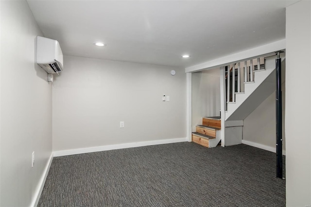 basement featuring dark colored carpet and a wall mounted air conditioner