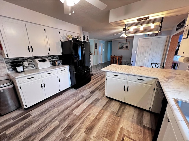 kitchen featuring black appliances, ceiling fan, white cabinetry, and tasteful backsplash