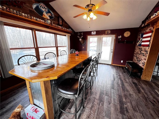 dining room featuring ceiling fan, french doors, dark wood-type flooring, and vaulted ceiling