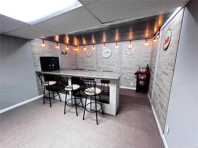 bar featuring a drop ceiling