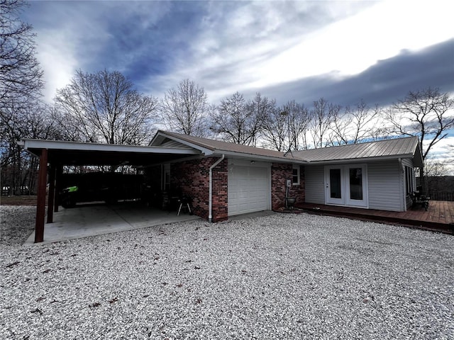 single story home featuring a carport, a garage, and a deck