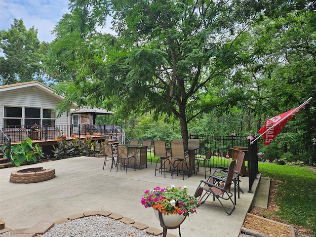 view of patio / terrace with a deck and a fire pit