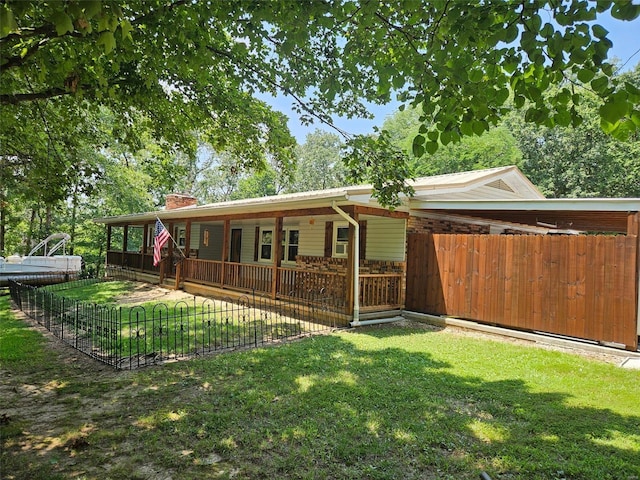 rear view of property with a yard