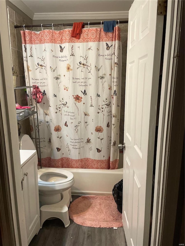 full bathroom featuring crown molding, vanity, hardwood / wood-style floors, and shower / bath combo with shower curtain