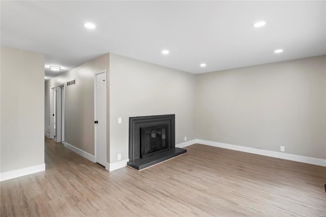 unfurnished living room with light hardwood / wood-style floors