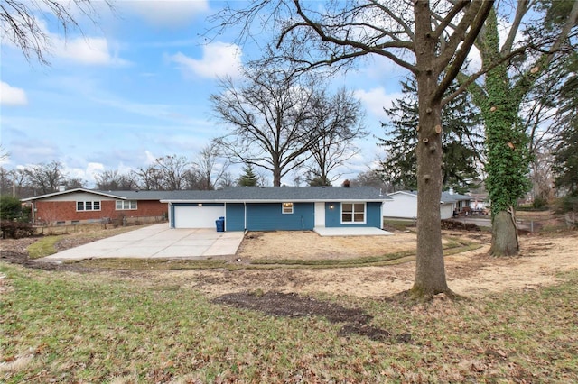 view of front of house with a patio area, a front yard, and a garage