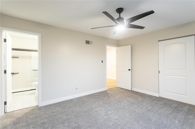 unfurnished bedroom featuring ensuite bath, ceiling fan, a closet, and carpet