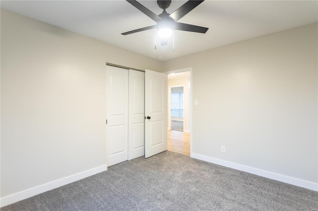 unfurnished bedroom featuring carpet flooring, a closet, and ceiling fan