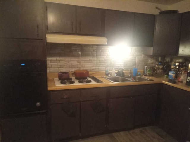 kitchen with exhaust hood, sink, backsplash, and white gas stovetop