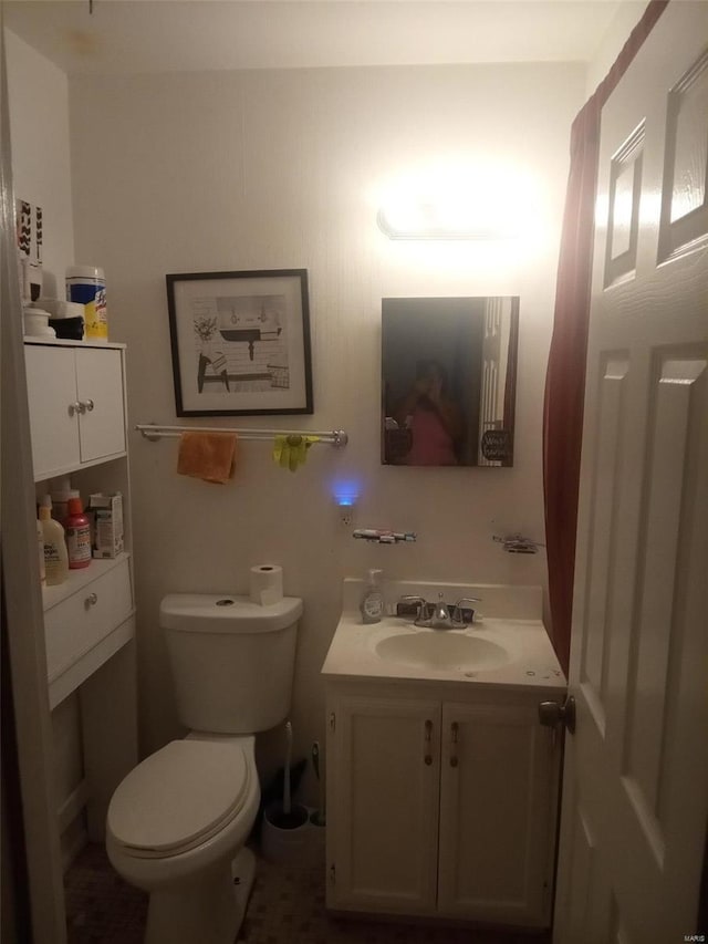 bathroom featuring vanity and toilet