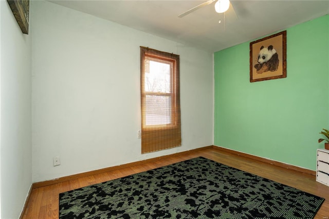 unfurnished room with hardwood / wood-style floors and ceiling fan