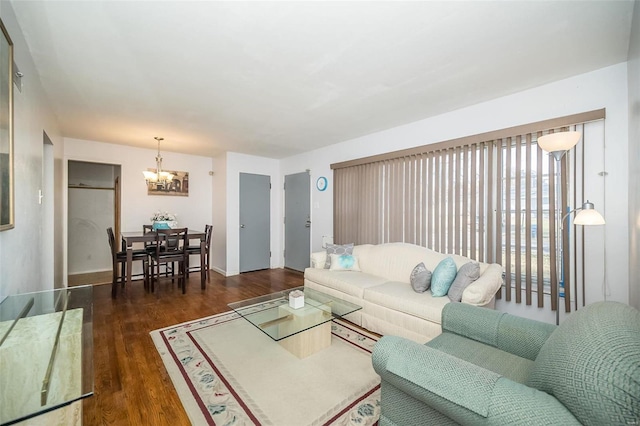 living room featuring dark hardwood / wood-style floors and a notable chandelier