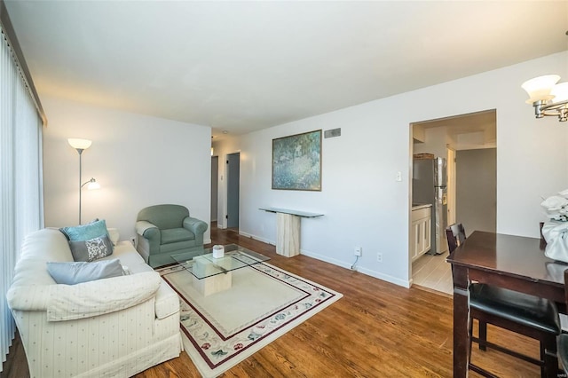 living room with a chandelier and wood-type flooring