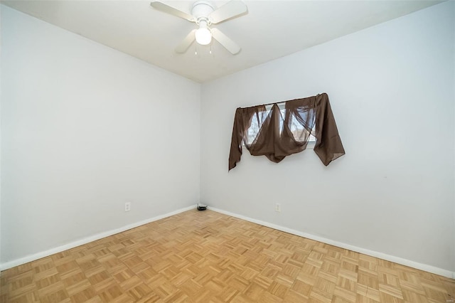 empty room featuring ceiling fan and light parquet flooring