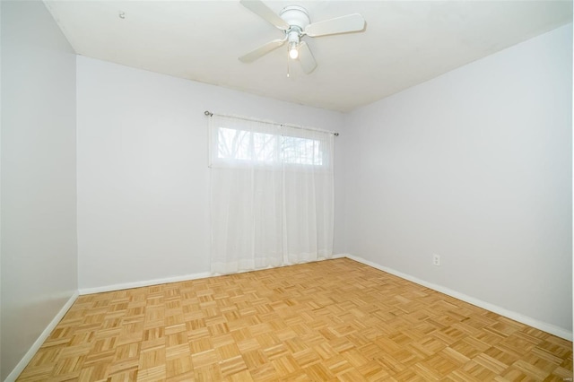 empty room featuring ceiling fan and light parquet flooring